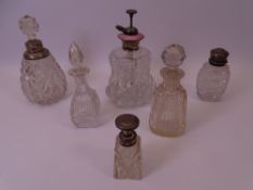 SILVER, WHITE METAL MOUNTED & GLASS TOPPED SCENT BOTTLES (6) to include a cut glass bell shaped