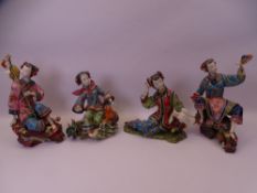 COLOURFUL MODERN CHINESE POTTERY FIGURINES OF YOUNG GIRLS in various seated positions, 27cms H the