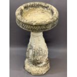 RECONSTITUTED STONE BIRD BATH, the 38cms diameter top on a bulbous column base, 69cms H