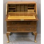 VINTAGE BURR WALNUT FALL-FRONT BUREAU with interior drawers and pigeonholes over three drawers on