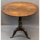 ANTIQUE OAK TILT-TOP TRIPOD TABLE having a 76cms diameter top on a turned column base and three