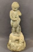 RECONSTITUTED STONE GARDEN FOUNTAIN depicting a young boy with a dolphin on a rocky base, 63cms H