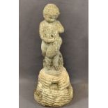 RECONSTITUTED STONE GARDEN FOUNTAIN depicting a young boy with a dolphin on a rocky base, 63cms H