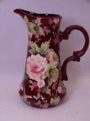 OLD TUPTON WARE TUBELINED JUG floral decorated on a wine colour ground, 24.5cms H, boxed