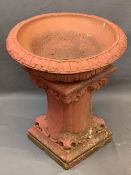 RECONSTITUTED STONE GARDEN PLANTER PAINTED RED having a dished top with acanthus leaf decoration,