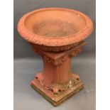 RECONSTITUTED STONE GARDEN PLANTER PAINTED RED having a dished top with acanthus leaf decoration,