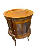 REPRODUCTION HARDWOOD DRUM TYPE DRINKS CABINET having a lift-off circular tray top, beaded and