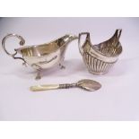 HALLMARKED SILVER, THREE ITEMS to include a three footed sauce boat with scroll handle, Sheffield