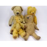 FOUR PLAYWORN VINTAGE TEDDY BEARS in wool and plush mohair, all with jointed limbs, 40cms L the