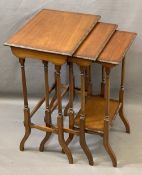 EDWARDIAN MAHOGANY NEST OF THREE OCCASIONAL TABLES with beaded edge detail on turned and splayed