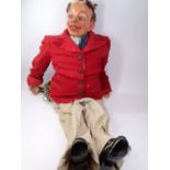 EARLY TO MID 20TH CENTURY PAPIER MACHE VENTRILOQUIST DUMMY sporting a red jacket and turn up pants