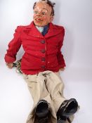 EARLY TO MID 20TH CENTURY PAPIER MACHE VENTRILOQUIST DUMMY sporting a red jacket and turn up pants