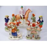 STAFFORDSHIRE COW SPILL HOLDERS, other figural groups and a cottage including a Jockey on horseback,
