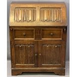 PRIORY STYLE OAK LINENFOLD CARVED FALL-FRONT BUREAU, the fall interior with a fitted arrangement