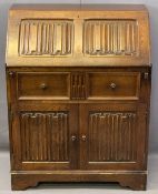 PRIORY STYLE OAK LINENFOLD CARVED FALL-FRONT BUREAU, the fall interior with a fitted arrangement