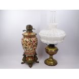 VICTORIAN OIL LAMPS (2) including a Persian type decorated pottery and cast metal example in a
