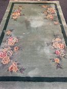 GREEN GROUND CHINESE WASHED WOOLLEN RUG, G H Ffrith Ltd with corner floral sprays, single band