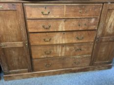 A SUBSTANTIAL WARDROBE/HOUSEKEEPER'S CUPBOARD BASE having four long and two short drawers to a