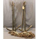 TWO LARGE CAST IRON BOAT ANCHORS and a length of heavy link chain, 113 x 70cms the anchors,