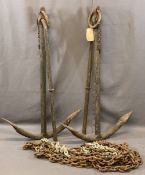 TWO LARGE CAST IRON BOAT ANCHORS and a length of heavy link chain, 113 x 70cms the anchors,