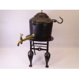 CAST IRON TWO GALLON TEA URN marked 'A Kenrick & Sons' on a four footed stand