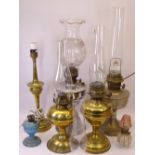 OIL LAMPS & LIGHTING an assortment with accompanying chimneys and an etched glass shade