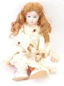 A FRENCH PORCELAIN HEADED DOLL, 20TH CENTURY marks to the neck 'GP92 S.P.B.J. 247 Paris', 43cms L
