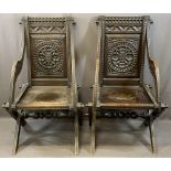 CARVED OAK CAMPAIGN STYLE ARMCHAIRS, A PAIR, pegged for dismantling construction with carved