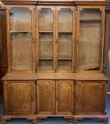 LATE 19th CENTURY INVERTED BOOKCASE CUPBOARD, two piece, the upper section with four long glazed