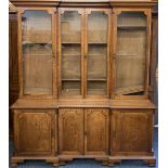 LATE 19th CENTURY INVERTED BOOKCASE CUPBOARD, two piece, the upper section with four long glazed