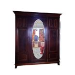 CIRCA 1900 INLAID MAHOGANY TRIPLE WARDROBE having central oval mirrored door and flanking boxwood