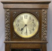 EARLY 20TH CENTURY CARVED LONGCASE CLOCK with silvered circular dial, twin weight, pendulum driven