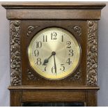 EARLY 20TH CENTURY CARVED LONGCASE CLOCK with silvered circular dial, twin weight, pendulum driven