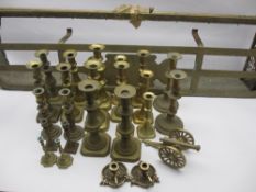 BRASSWARE - a pair of thistle candleholders, approximately 12 pairs of candlesticks and two fire