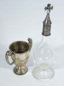 ECCLESIASTICAL SILVER TOPPED GLASS DECANTER and a twin-handled trophy cup, London hallmarks 1927,