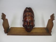 VINTAGE WOODEN SLIDING BOOKSHELF and an African wall hanging mask