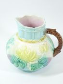 MAJOLICA TYPE FLORAL DECORATED JUG - 17cms tall