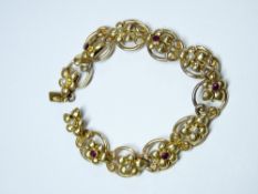 SEED PEARL & GARNET TYPE STONE SET BRACELET STAMPED 'PATENT 15C' in the form of floral topped