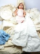 VINTAGE COMPOSITION DOLL and a quantity of Victorian children's clothes including gown, cape,