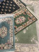 EASTERN/ORIENTAL STYLE WOOLLEN CARPETS (4) - in various greens with traditional and floral central