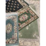 EASTERN/ORIENTAL STYLE WOOLLEN CARPETS (4) - in various greens with traditional and floral central