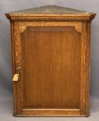 VINTAGE OAK WALL HANGING CORNER CUPBOARD having a dentil cornice and quarter cut pillars flanking