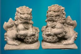 GARDEN STONEWARE - reconstituted statuary Chinese Temple lions, a pair holding an open carved ball