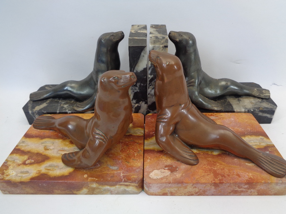 FRENCH CAST BRONZE & MARBLE BOOKENDS, TWO PAIRS - depicted as Sea Lions on black and pink marble