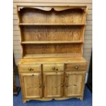 REPRODUCTION PINE KITCHEN DRESSER - having a three shelf rack over a base section of three frieze