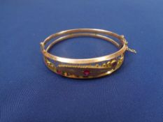 CHESTER 1908 9CT GOLD LADY'S BANGLE - open double frame style with ball and bar decorated top set