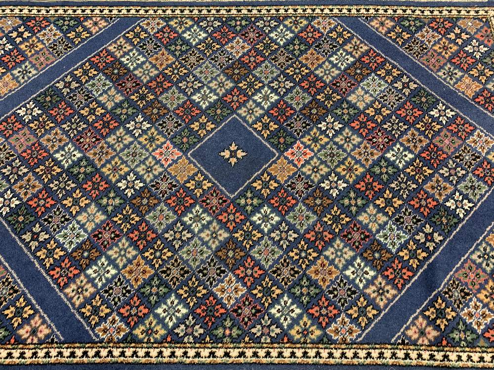 EASTERN STYLE BLUE GROUND CARPETS (2) - a repeating colourful floral pattern with bordered edge - Image 2 of 4