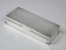 AN OBLONG ENGINE TURNED SILVER MOUNTED CIGARETTE BOX with two interior compartments and on neat