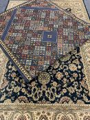 EASTERN STYLE BLUE GROUND CARPETS (2) - a repeating colourful floral pattern with bordered edge