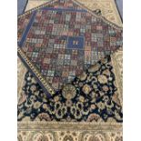 EASTERN STYLE BLUE GROUND CARPETS (2) - a repeating colourful floral pattern with bordered edge